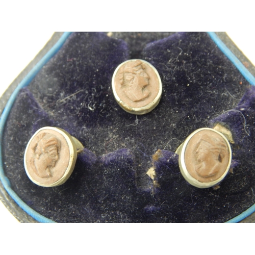 144 - A set of Victorian lava cameo carved profile shirt studs in original Glasgow retailers silk and leat... 