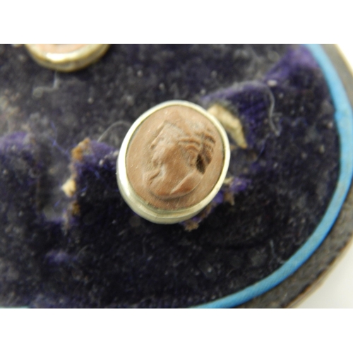 144 - A set of Victorian lava cameo carved profile shirt studs in original Glasgow retailers silk and leat... 