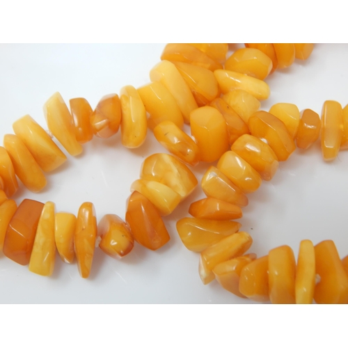 150 - A necklace of polished butterscotch amber free-form beads