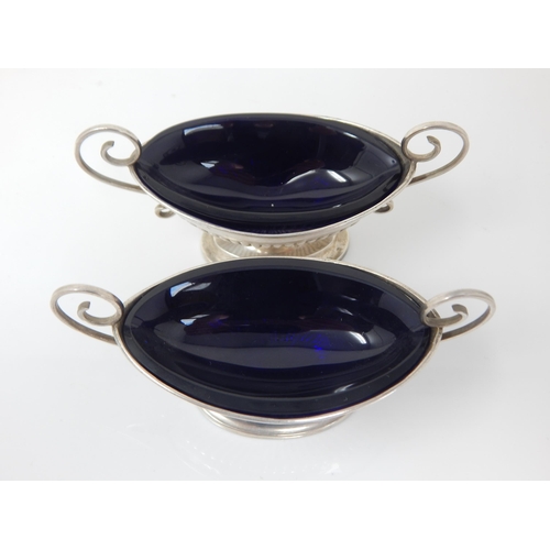 151 - A pair of Victorian silver blue-glass lined navette salts with scroll handles and gadroon bases – Ro... 