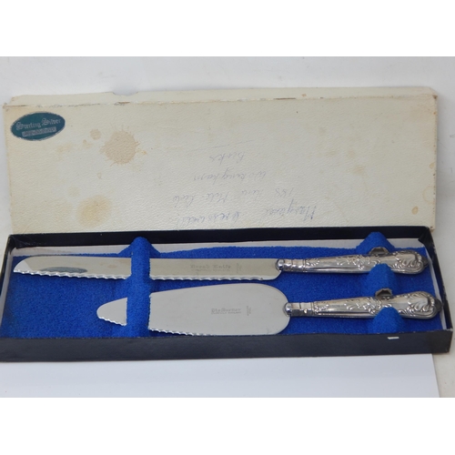 156 - A boxed set of vintage silver handled cake and bread knives – Sheffield 1972 – Harrison Brothers