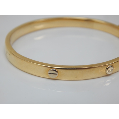 86 - 18ct Gold Hinged Bangle: Weight 19.64g