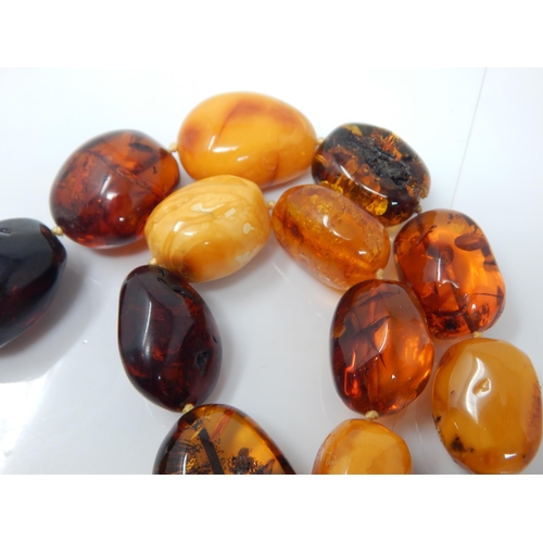 304 - Silver Mounted Large Amber Necklace: Weight 144g