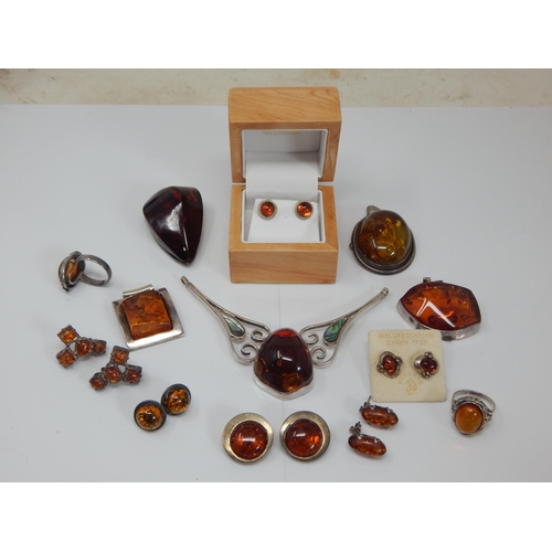 309 - Quantity of Silver Mounted Amber Jewellery: Gross weight 200g