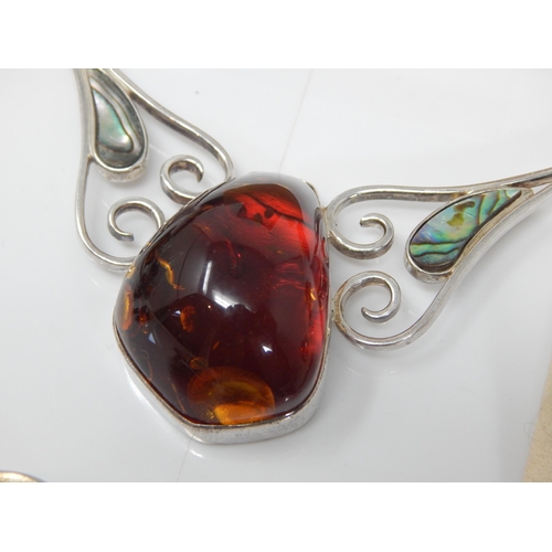 309 - Quantity of Silver Mounted Amber Jewellery: Gross weight 200g
