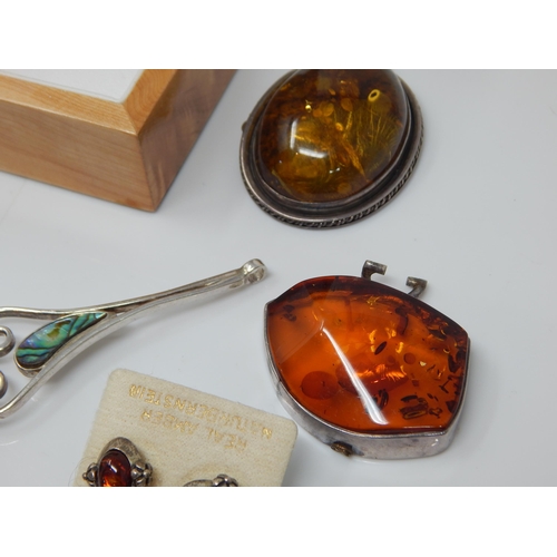 309 - Quantity of Silver Mounted Amber Jewellery: Gross weight 200g