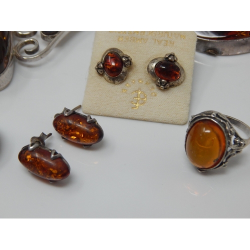 309 - Quantity of Silver Mounted Amber Jewellery: Gross weight 200g