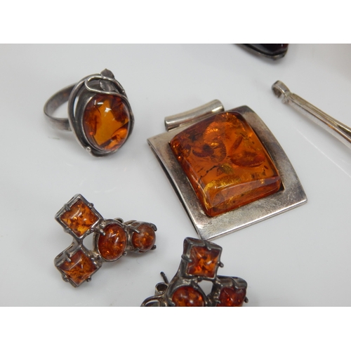 309 - Quantity of Silver Mounted Amber Jewellery: Gross weight 200g