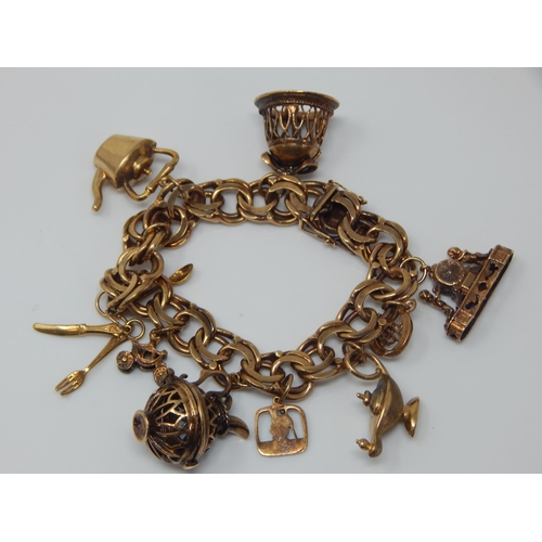 340 - 9ct Gold Charm Bracelet with Numerous Charms: Weight 65.61g