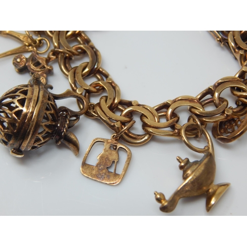 340 - 9ct Gold Charm Bracelet with Numerous Charms: Weight 65.61g