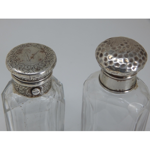 77 - A Victorian Silver Mounted Cut Glass Scent Bottle Hallmarked London 1855 together with another.