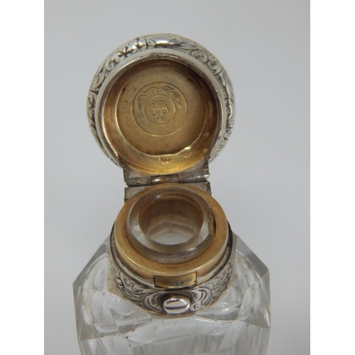 77 - A Victorian Silver Mounted Cut Glass Scent Bottle Hallmarked London 1855 together with another.