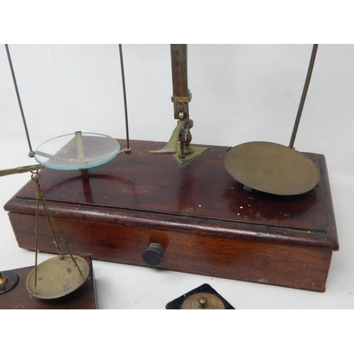 221 - Two Sets of Brass Beam Scales together with a full set of weights.