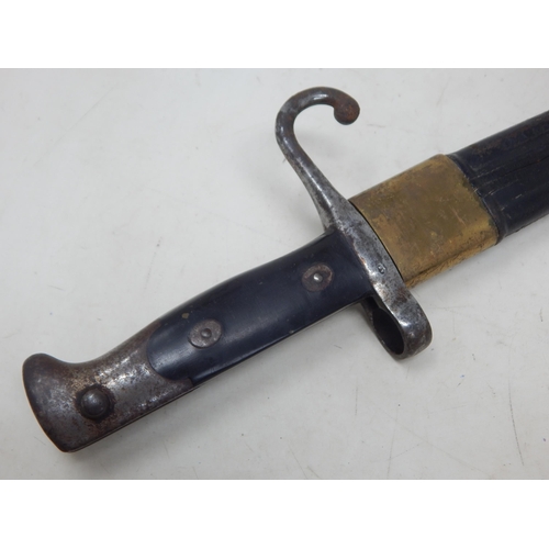 307J - WWI Caricano Bayonet with brass mounted leather scabbard. Overall length 66cm