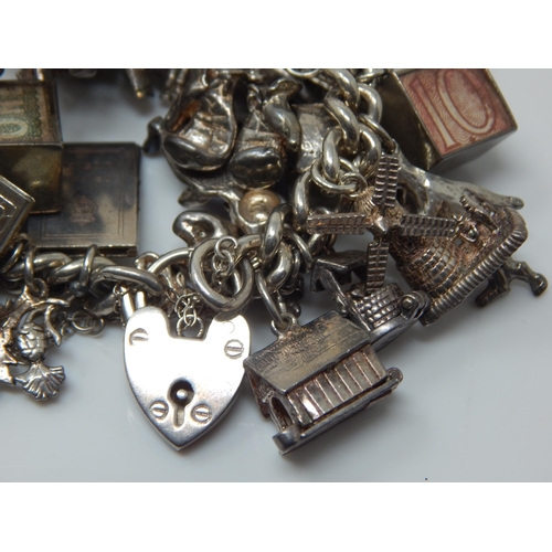 101T - Heavy Silver Charm Bracelet with Numerous Charms: Weight 174g