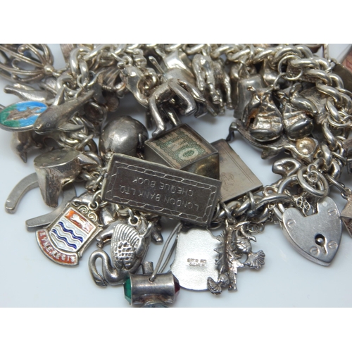 101T - Heavy Silver Charm Bracelet with Numerous Charms: Weight 174g