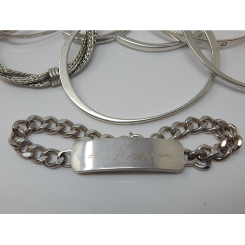 101W - A Quantity of Sterling Silver Bangles/Bracelets together with a Sterling Silver Identity Bracelet: W... 