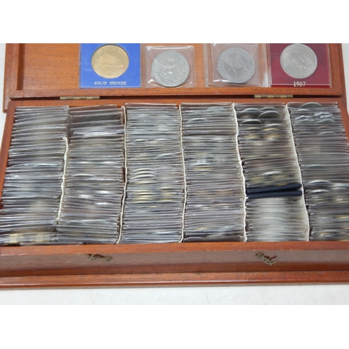 31 - A large collection of coins mostly base metal housed in plastic enveloped within wooden box (lot)