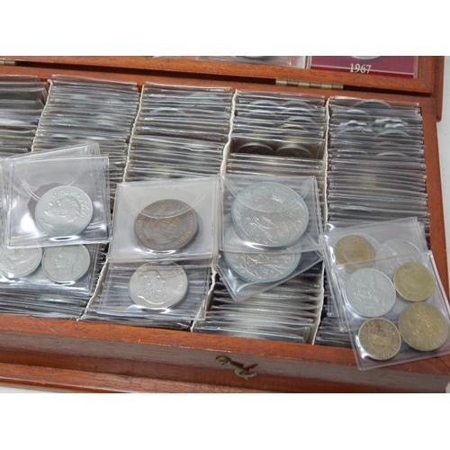 31 - A large collection of coins mostly base metal housed in plastic enveloped within wooden box (lot)