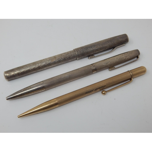 68 - 9ct Gold propelling pencil twinned with a pair of Sterling Silver pencils