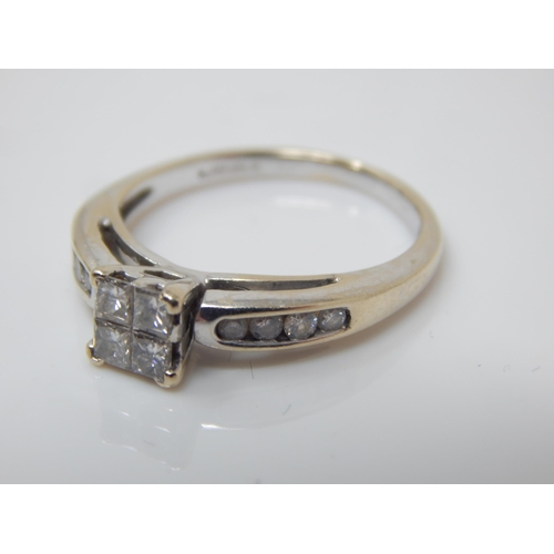 200 - 18ct White Gold Ring Set with Four Central Princess Cut Diamonds & Having Diamond Set Shoulders; Siz... 