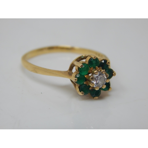 260B - 18ct Gold Ring Set with a Central Diamond within a Border of 7 Emeralds: Size O:  Weight 2.62g