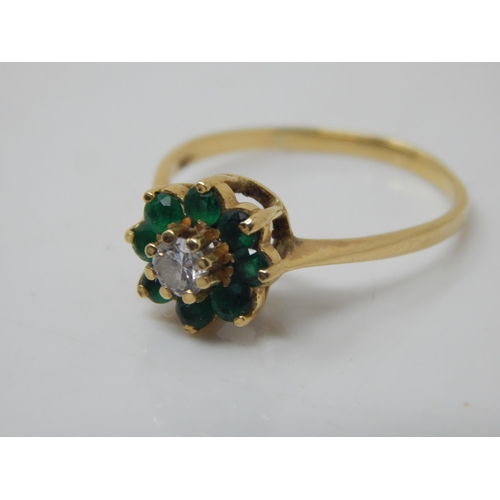 260B - 18ct Gold Ring Set with a Central Diamond within a Border of 7 Emeralds: Size O:  Weight 2.62g