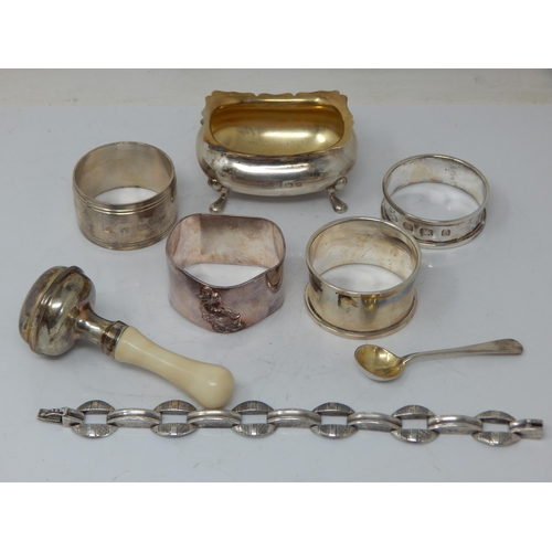 66 - A children's silver rattle, group of hallmarked Silver napkin rings, etc total weight 189.43g.