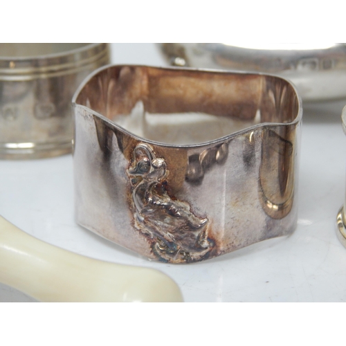 66 - A children's silver rattle, group of hallmarked Silver napkin rings, etc total weight 189.43g.