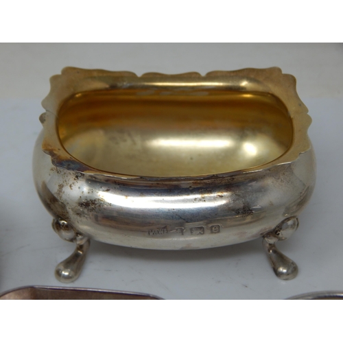 66 - A children's silver rattle, group of hallmarked Silver napkin rings, etc total weight 189.43g.
