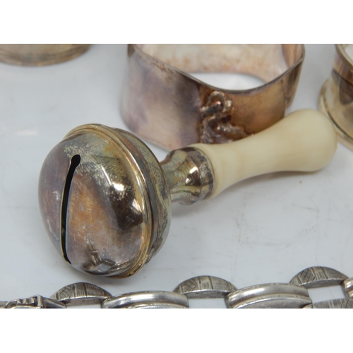 66 - A children's silver rattle, group of hallmarked Silver napkin rings, etc total weight 189.43g.