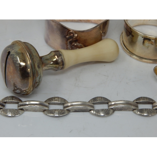 66 - A children's silver rattle, group of hallmarked Silver napkin rings, etc total weight 189.43g.