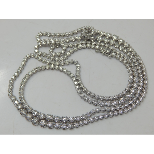 91 - A Long 18ct White Gold  Diamond Line Necklace, set throughout with Brilliant Cut Diamonds, stamped ‘... 