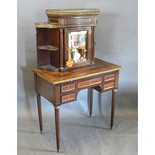 703 - A 19th Century French Bonheur du Jour, the marble topped and brass galleried super structure with a ...
