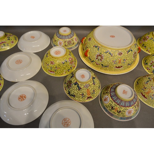 42 - A Chinese Famille Rose Service with allover decoration upon a yellow ground comprising tureen, bowls... 