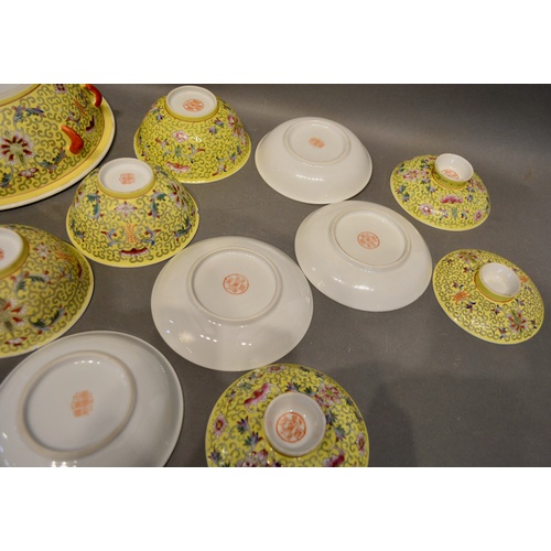 42 - A Chinese Famille Rose Service with allover decoration upon a yellow ground comprising tureen, bowls... 