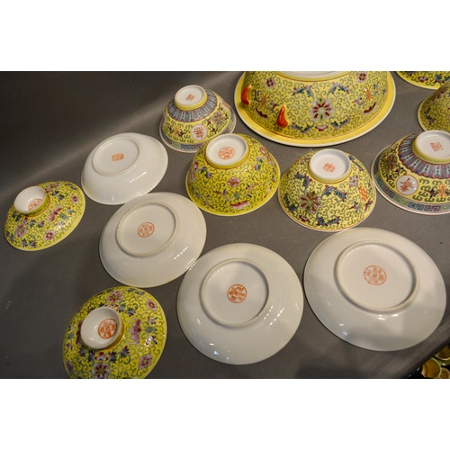 42 - A Chinese Famille Rose Service with allover decoration upon a yellow ground comprising tureen, bowls... 