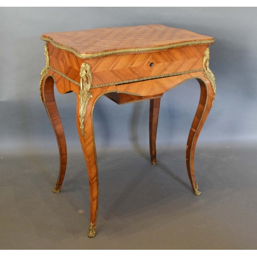 577 - A French Kingwood and Gilt Metal Mounted Work Table, the serpentine parquetry inlaid hinged top encl... 