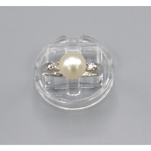 174 - A 18ct White Gold Pearl and Diamond Ring set with a large central pearl surrounded by two diamonds w... 