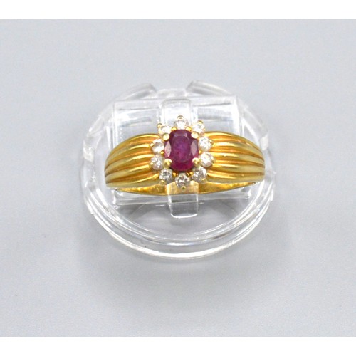 178 - A tested 18ct Yellow Gold Ruby and Diamond Ring set with central ruby surrounded by diamonds within ... 