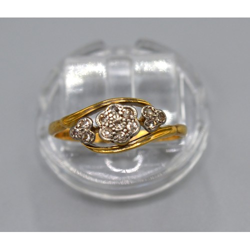 183 - A 18ct Yellow Gold Diamond Ring set with three clusters of diamonds within a crossover setting, size... 
