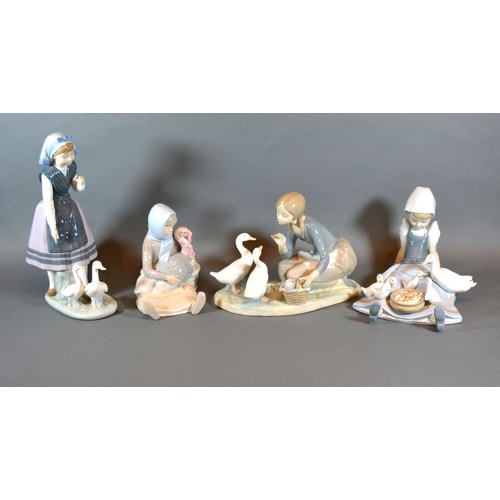 1 - A Lladro Figurine in the form of a Girl Feeding Ducks together with three other similar Lladro figur... 