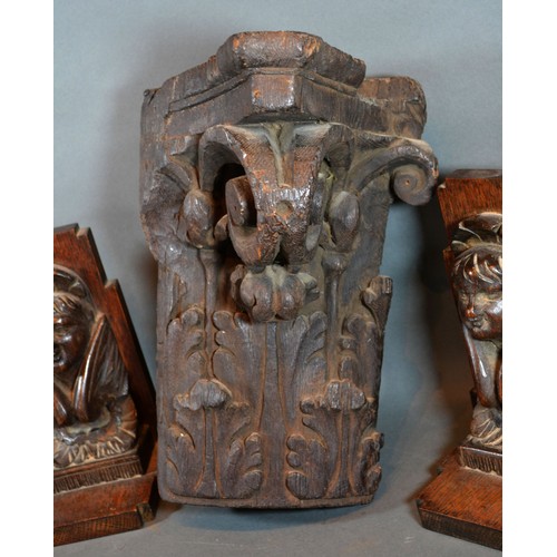 335 - An Early Carved Oak Corner Bracket together with a pair of similar carved oak bookends