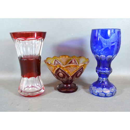 44 - A Bohemian Blue Glass Goblet, 20 cms tall together with a Ruby Glass Vase and a similar pedestal bow... 