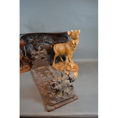 343 - A 19th Century Black Forest Folding Book Stand together with two similar carved models of Stags and ... 