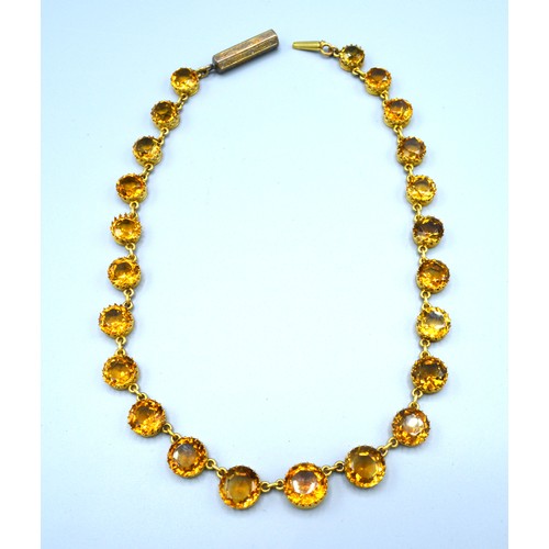 178 - A Yellow Metal Citrine Set Necklace with graduated stones and interspaced with links, 38 cms long