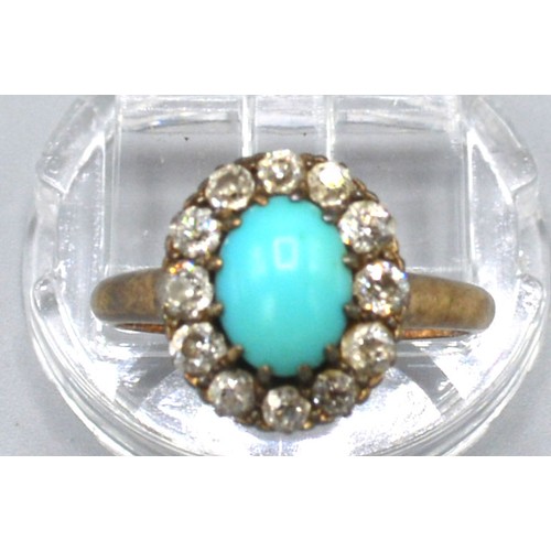 182 - A Yellow Metal Turquoise and Diamond Set Cluster Ring with a central oval cabochon turquoise surroun... 