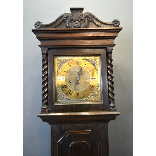 412 - An Oak Longcase Clock, the square hood with barley twist columns and shaped cresting above a moulded... 