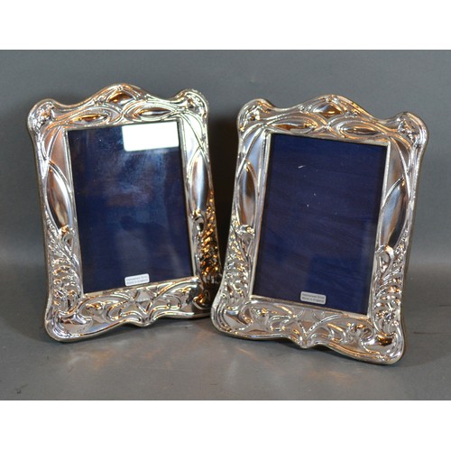 232 - A Pair of Art Nouveau Style Sterling Silver Photograph Frames with embossed decoration 20cm by 16cm