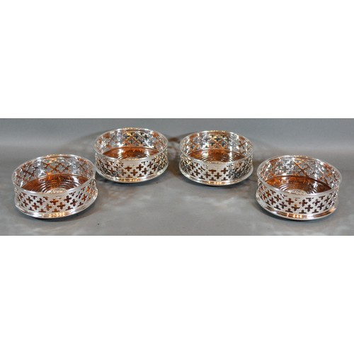 235 - A Set of Four Silver Plated and Turned Wooden Bottle Coasters of pierced form 12.5cm diameter